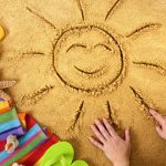 A képen egy homokba rajzolt nap látható