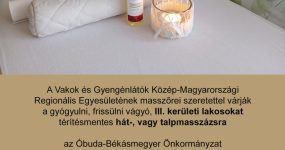 A képen a hirdetmény teljes szövege olvasható, felül a VGYKE és Óbuda logója látszik. Látható még egy masszázs ágy, fehér lepedővel és hengerpárnával, égő gyertyával és masszázsolajas üveggel.